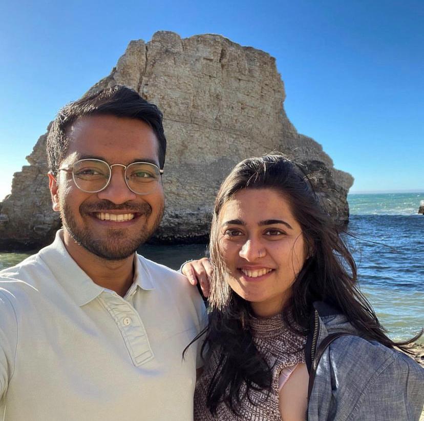 Karan and Prachi taking a smiling selfie by the ocean